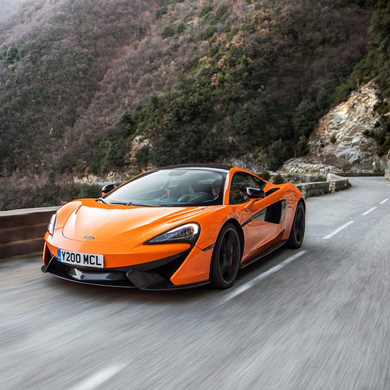 Orange McLaren driving in the mountains